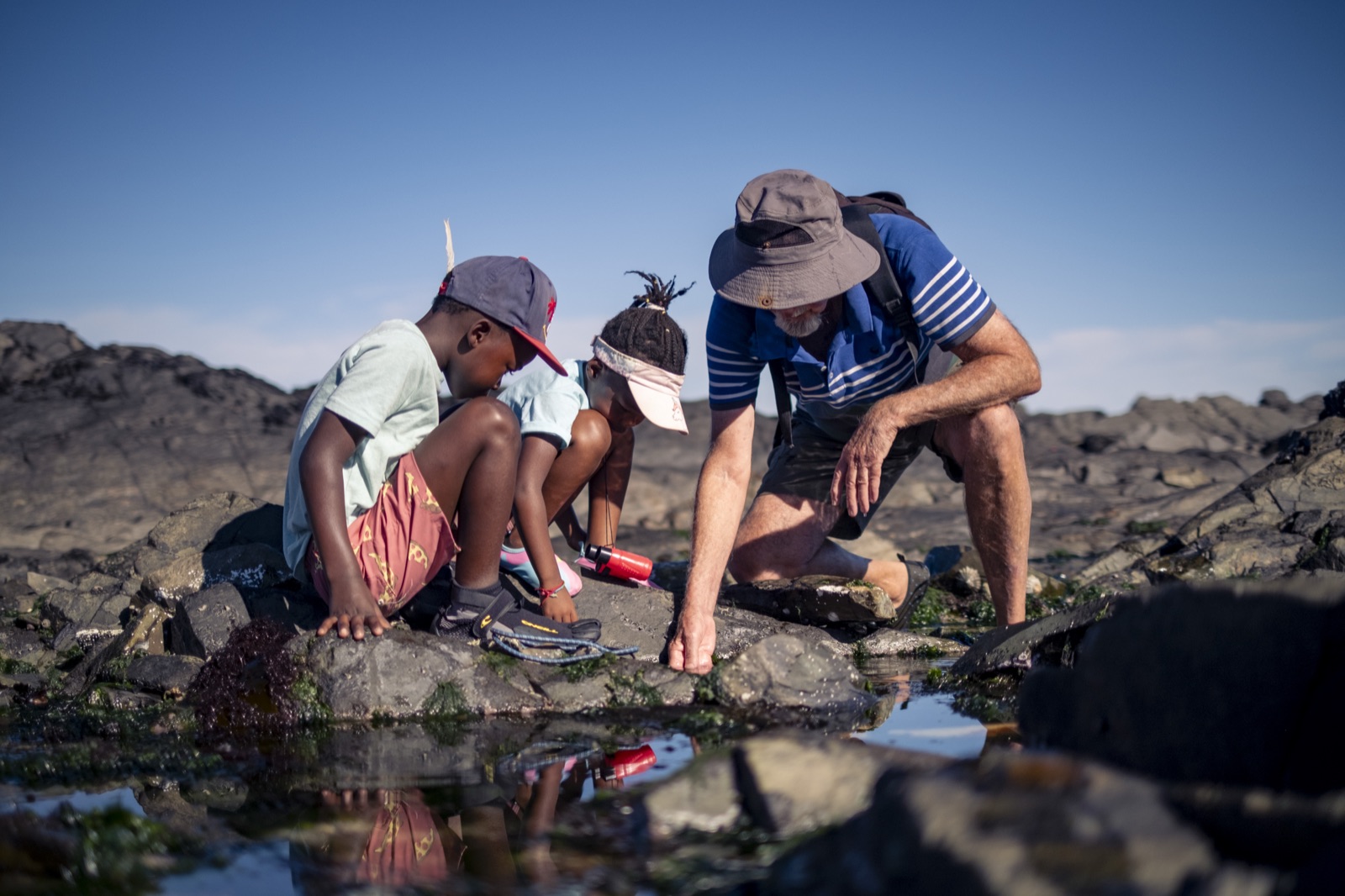 Charles Griffiths sharing marine finds with children on the shore